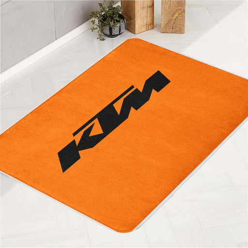 orange ktm racing logo black bath rugs